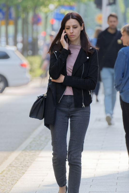 Young woman going and talking on the phone